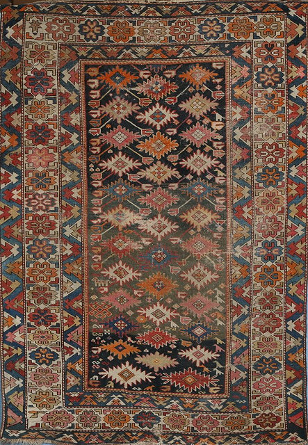 Appraisal: AN OLD CAUCASIAN RUG with a central polychrome star motif