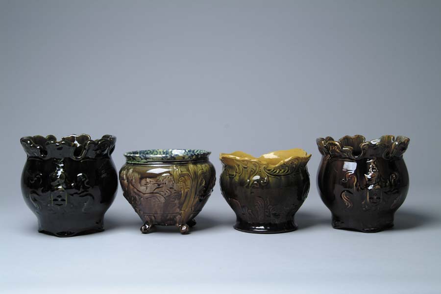 Appraisal: FOUR JARDINI RES Green-black glaze with crest of shield ruffled