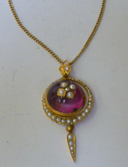 Appraisal: A VICTORIAN RED STONE AND HALF PEARL PENDANT the round