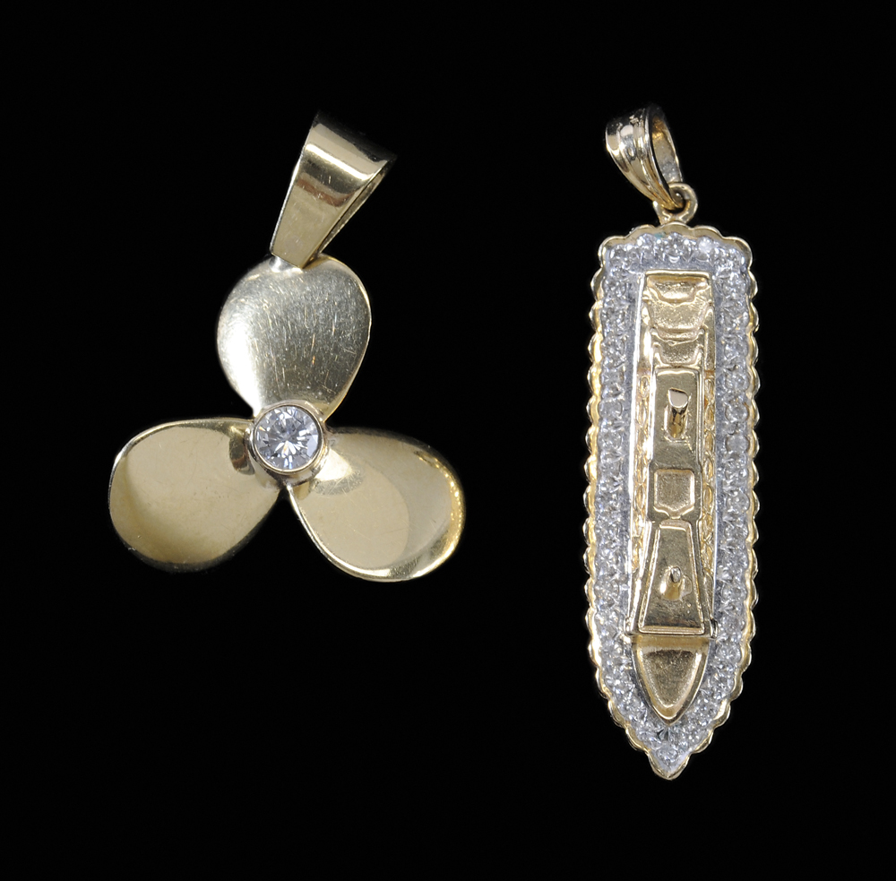 Appraisal: Two Gold Charms one kt cruise line ship with round