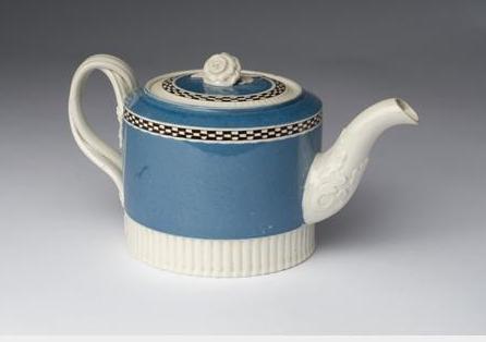 Appraisal: BRITISH CREAMWARE MOCHAWARE TEAPOT AND COVER CIRCA Of drum form