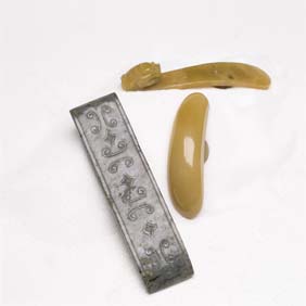 Appraisal: TWO BELT HOOKS AND A JADE FITTING Two Chinese caramel