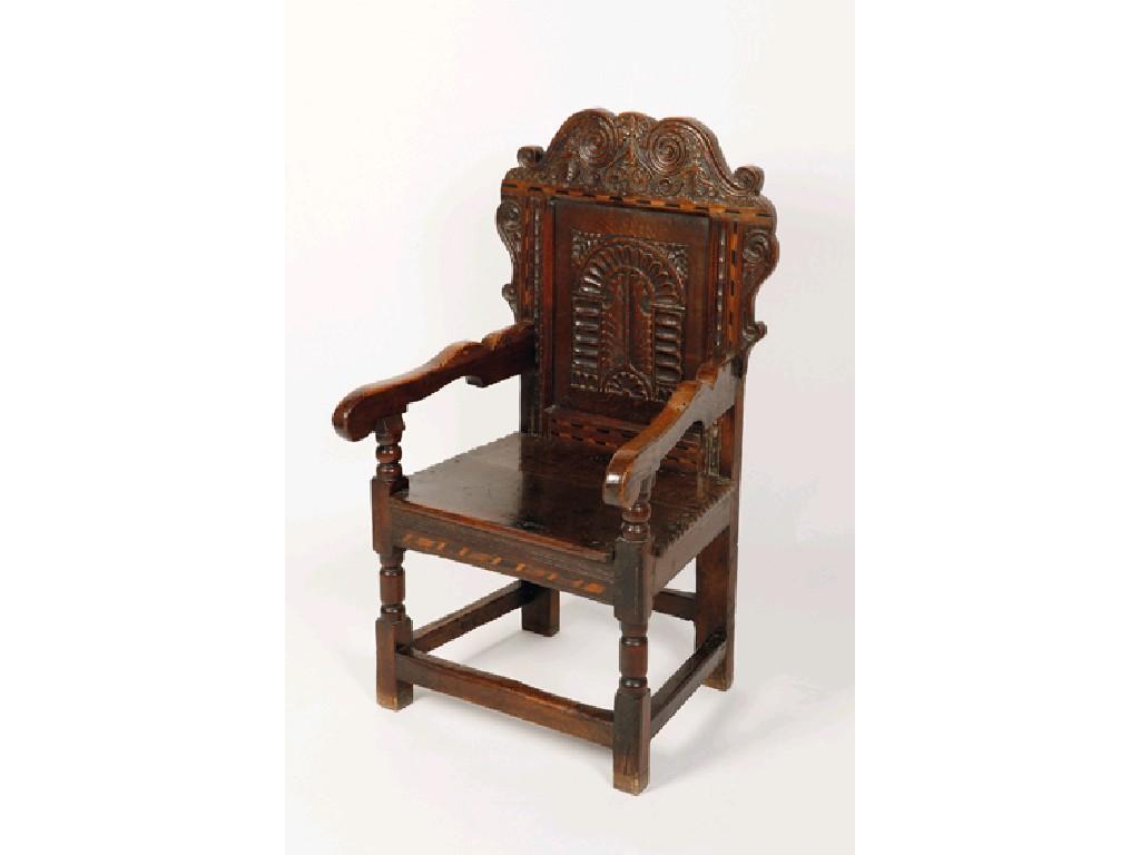 Appraisal: A CHARLES II OAK WAINSCOTE ARMCHAIR with a foliate carved