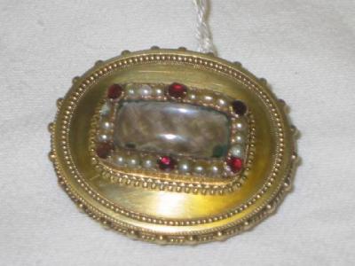 Appraisal: A PEARL AND GARNET MOURNING BROOCH of oval form the