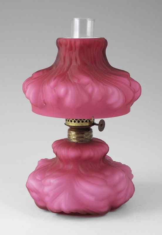 Appraisal: MINIATURE CRANBERRY GLASS OIL LAMP Satin glass cased in white