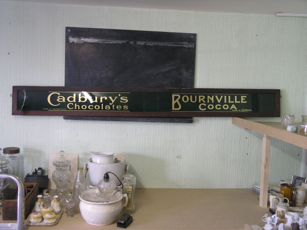 Appraisal: A confectioner's shop sign Cadbury's Bourneville transfer gilded glass sign