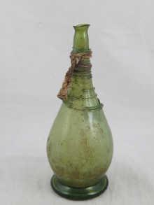 Appraisal: An th century Persian green glass standing bottle with trailed