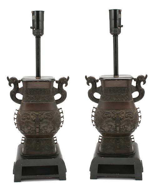 Appraisal: A pair of Chinese style Gu-form metal lamps height in