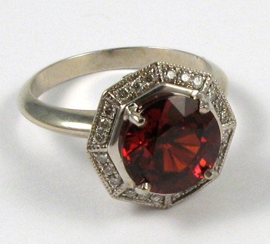 Appraisal: ORANGE SAPPHIRE AND DIAMOND RING The k white gold band