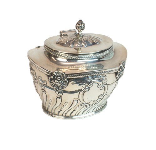 Appraisal: A silver hinge lidded tea caddy the body with partly