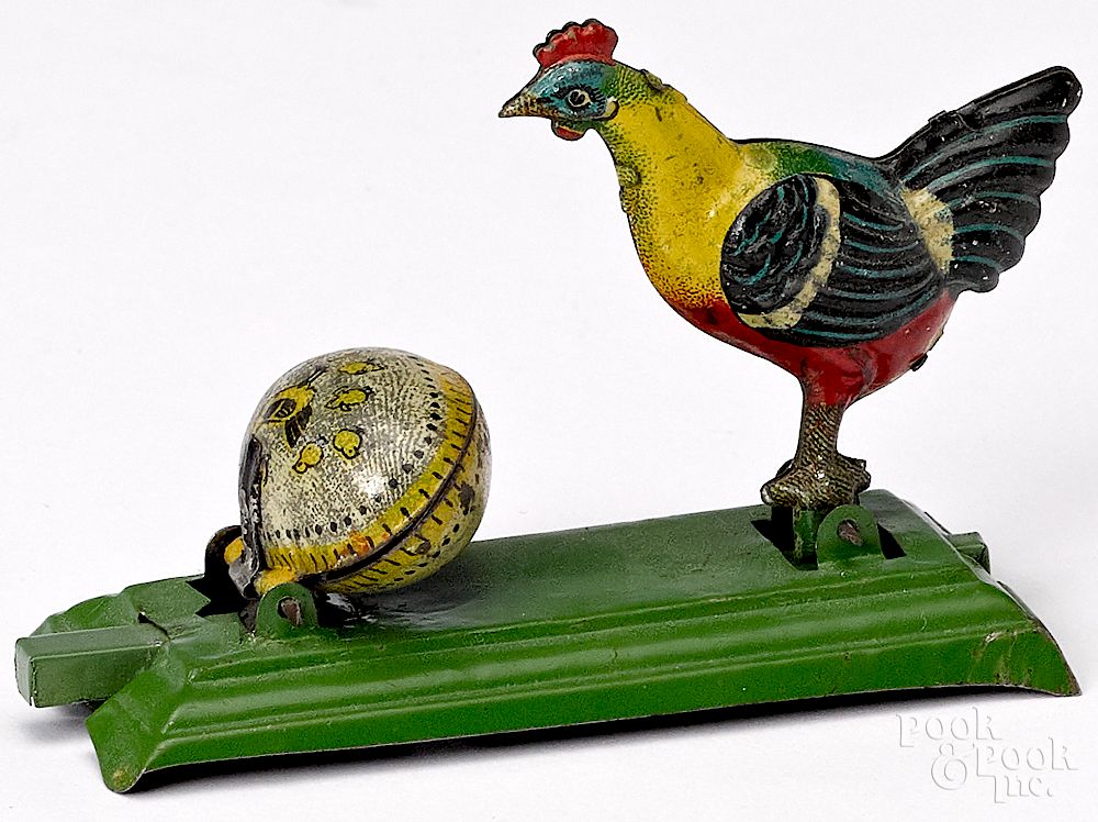 Appraisal: Tin animated chicken cracking egg penny toy Tin lithograph animated