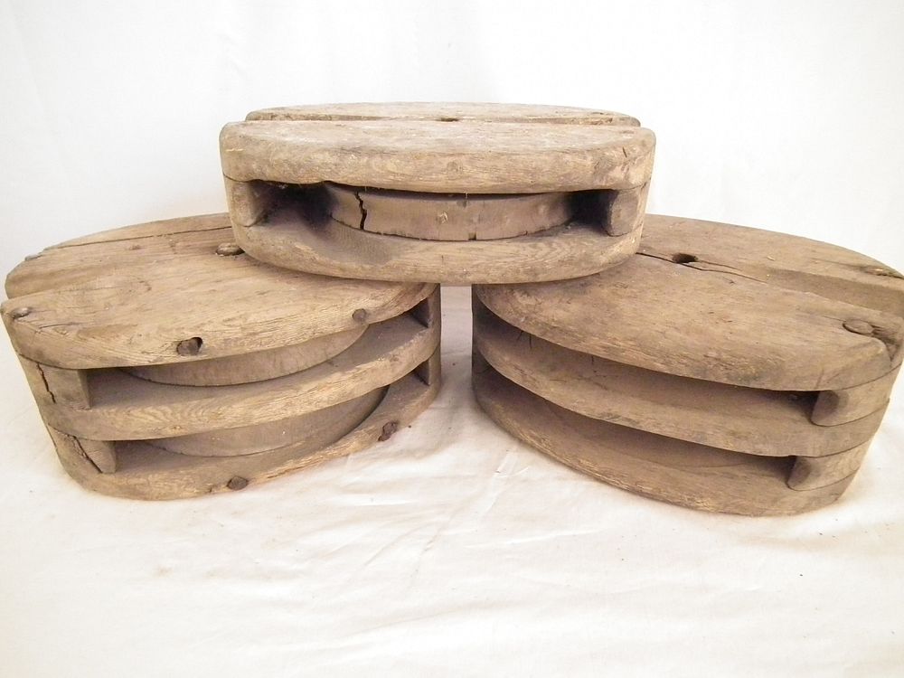 Appraisal: ANTIQUE PULLEY BLOCKS Antique wood pulley blocks a single and