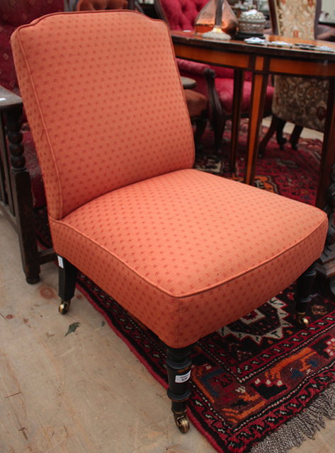 Appraisal: A VICTORIAN LOW OVERSTUFFED UPHOLSTERED CHAIR with square back and