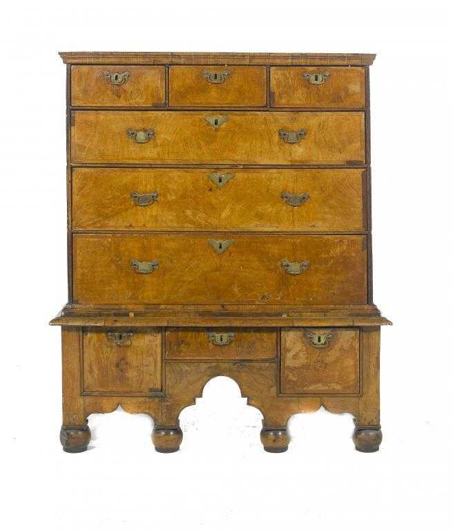 Appraisal: A GEORGE I WALNUT AND CROSSBANDED CHEST-ON-STAND with moulded cornice