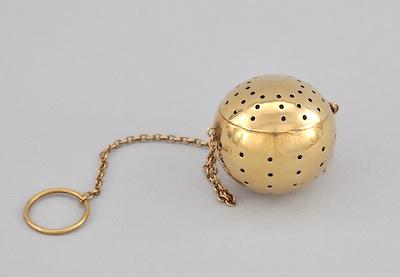 Appraisal: A K Yellow Gold Tea Ball The pierced ball has