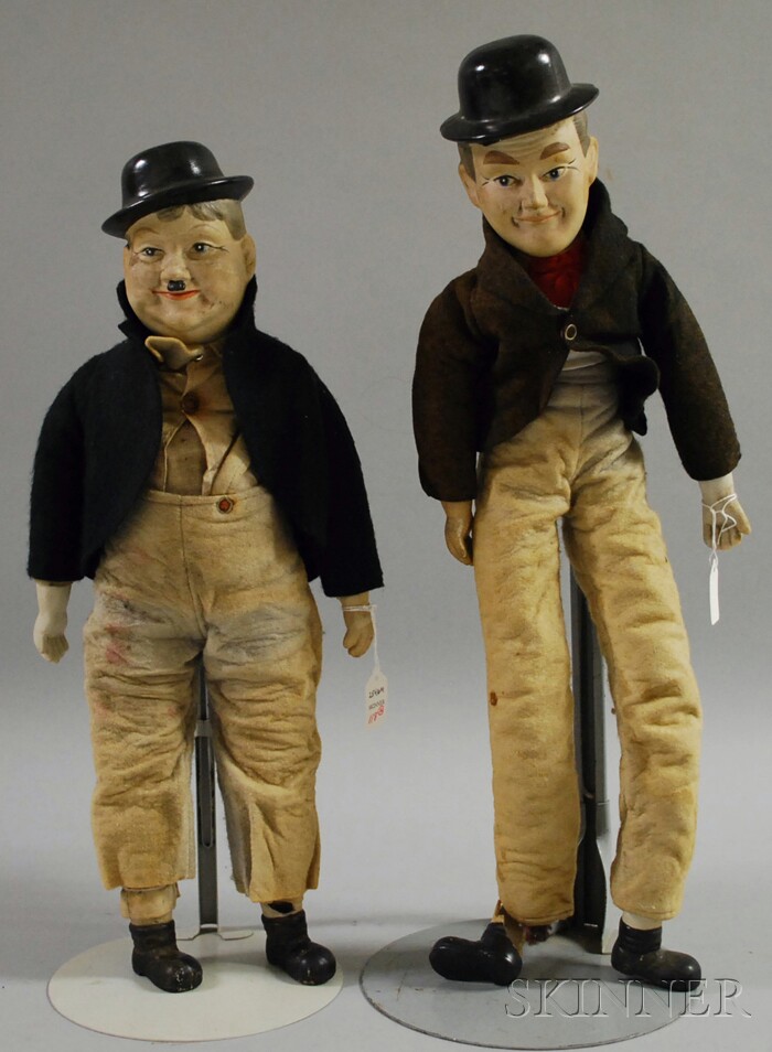 Appraisal: Laurel and Hardy Character Painted Bisque Shoulder Head Dolls with