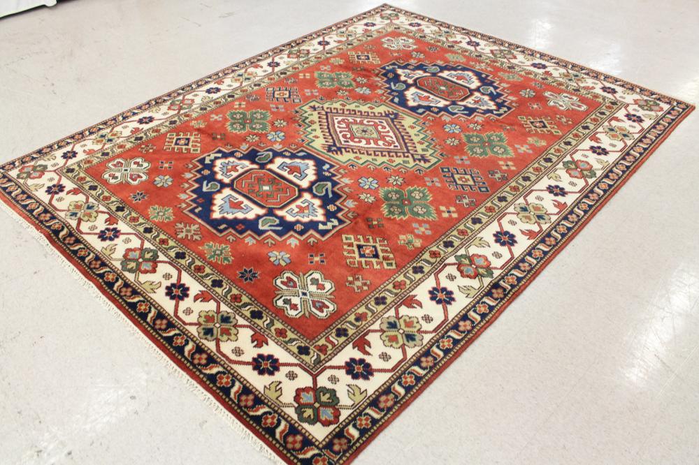 Appraisal: HAND KNOTTED ORIENTAL CARPET Indo-Persian three geometric medallions surrounded by