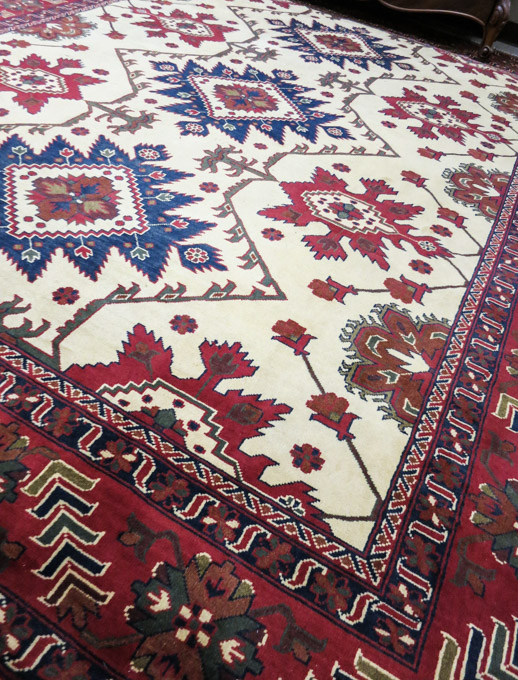 Appraisal: HAND KNOTTED ORIENTAL CARPET Pakistani Caucasian multiple geometric medallion and