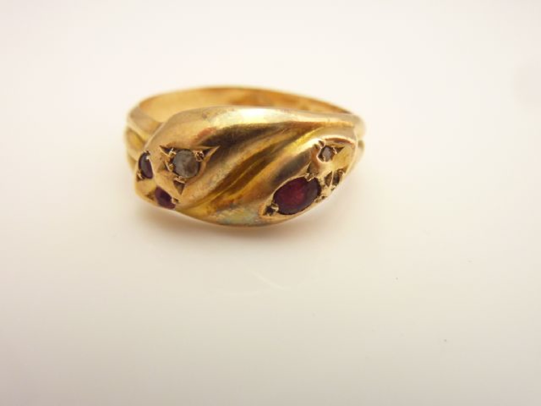 Appraisal: An Edwardian snake ring composed of two snake heads intertwining