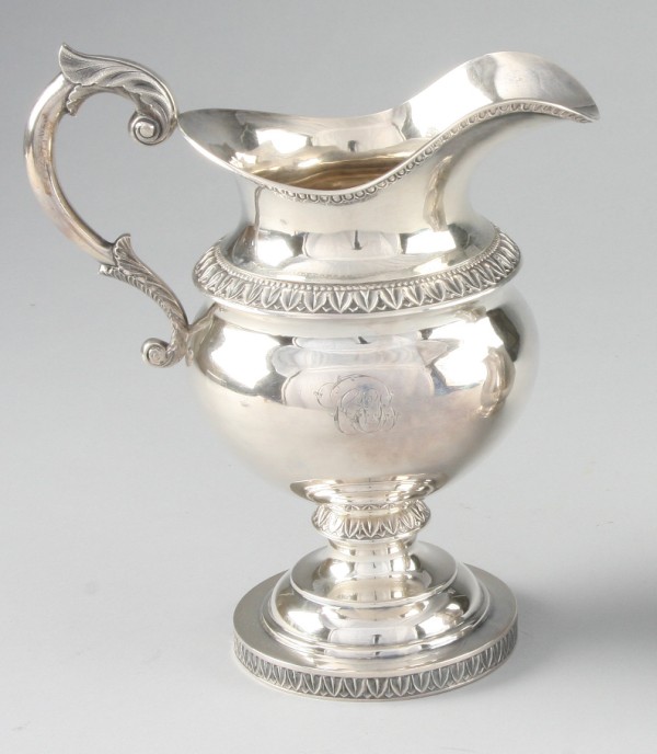 Appraisal: One monogrammed pitcher with decorative handle and acanthus leaf motif