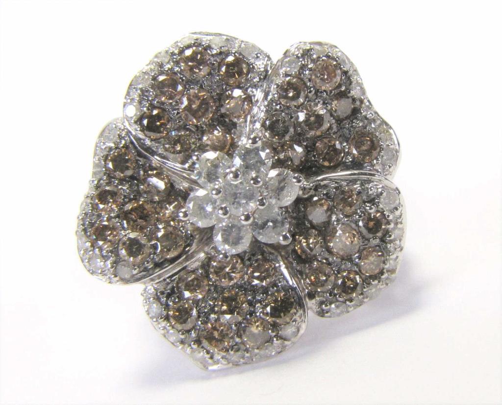 Appraisal: A K white gold flower design ring with seventy-seven brown