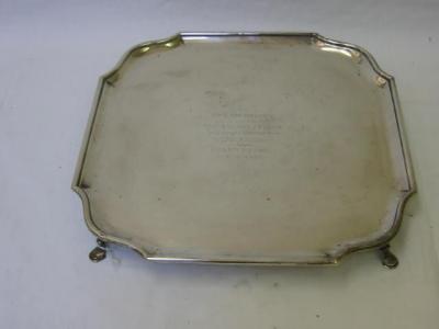 Appraisal: A SILVER PRESENTATION TRAY of shaped square form with moulded