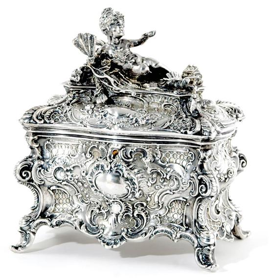 Appraisal: German silver sugar box circa recumbent cherub finial on bombe