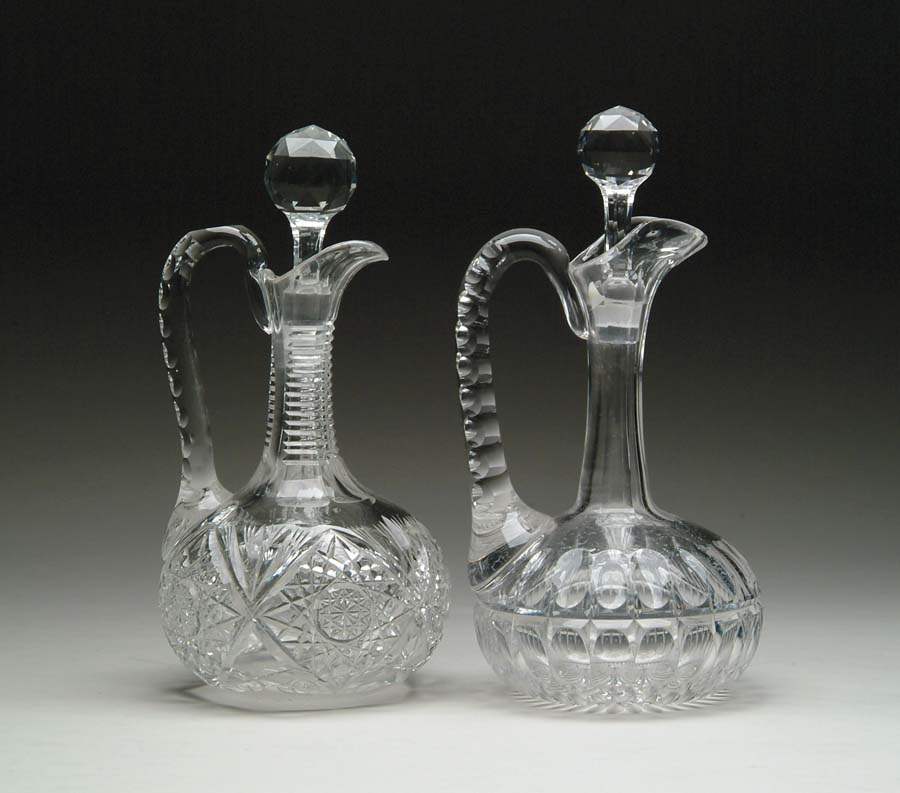 Appraisal: TWO CUT GLASS DECANTERS Decanter features concave handle cutting with