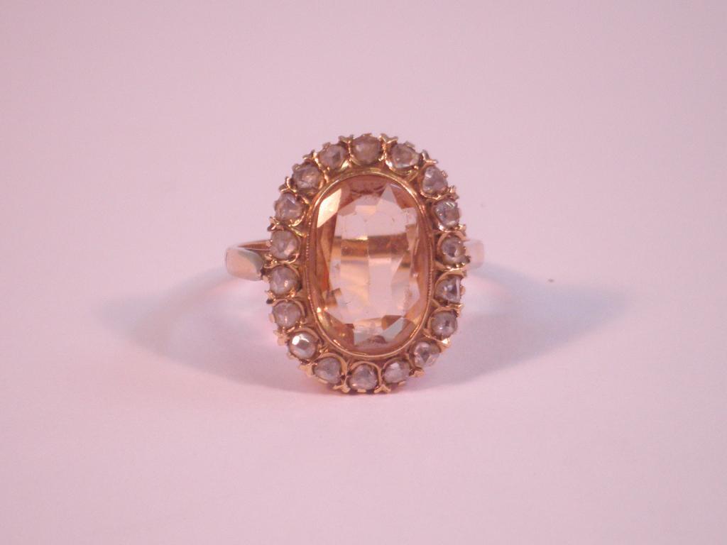 Appraisal: A yellow topaz and diamond cluster ring set in yellow