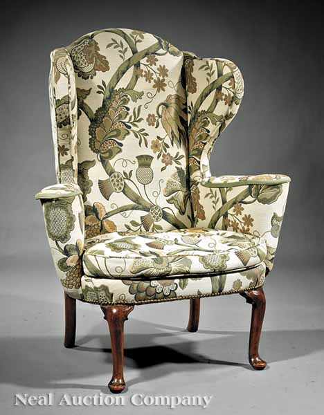 Appraisal: An Antique English Wing Chair with outscrolled wings and arms