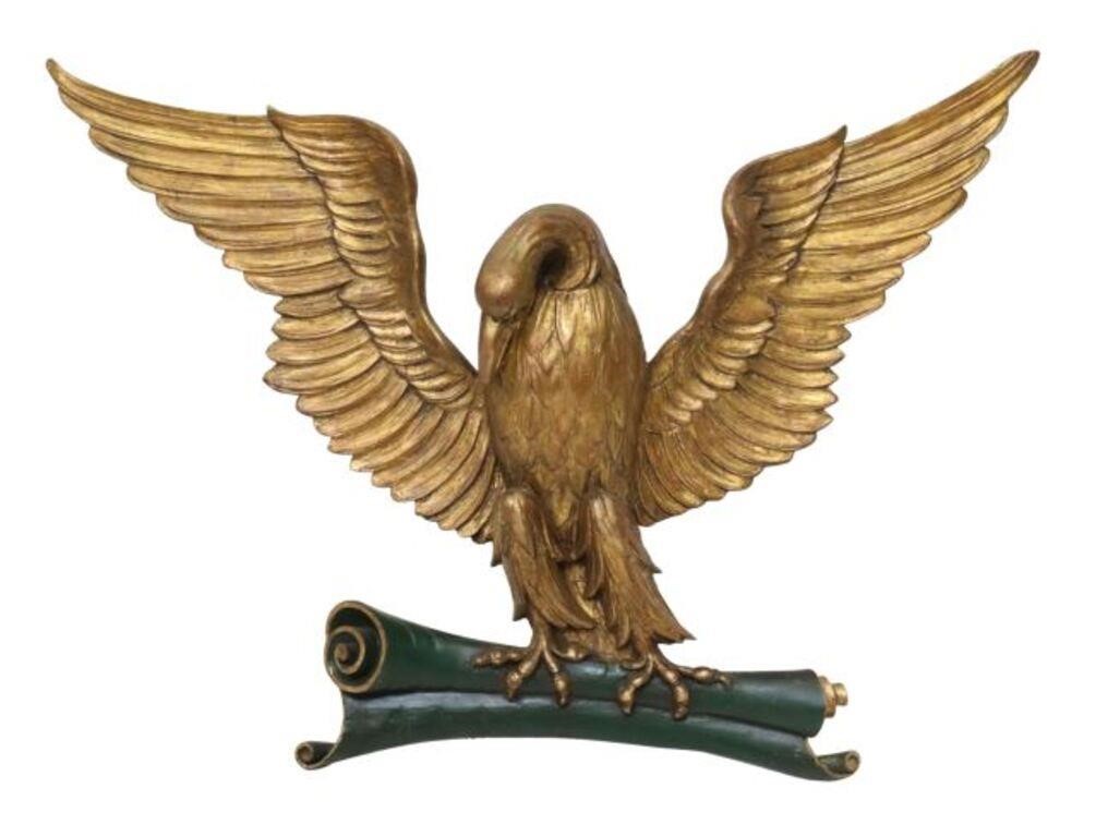 Appraisal: Carved giltwood eagle modeled with open wings grasping a scroll