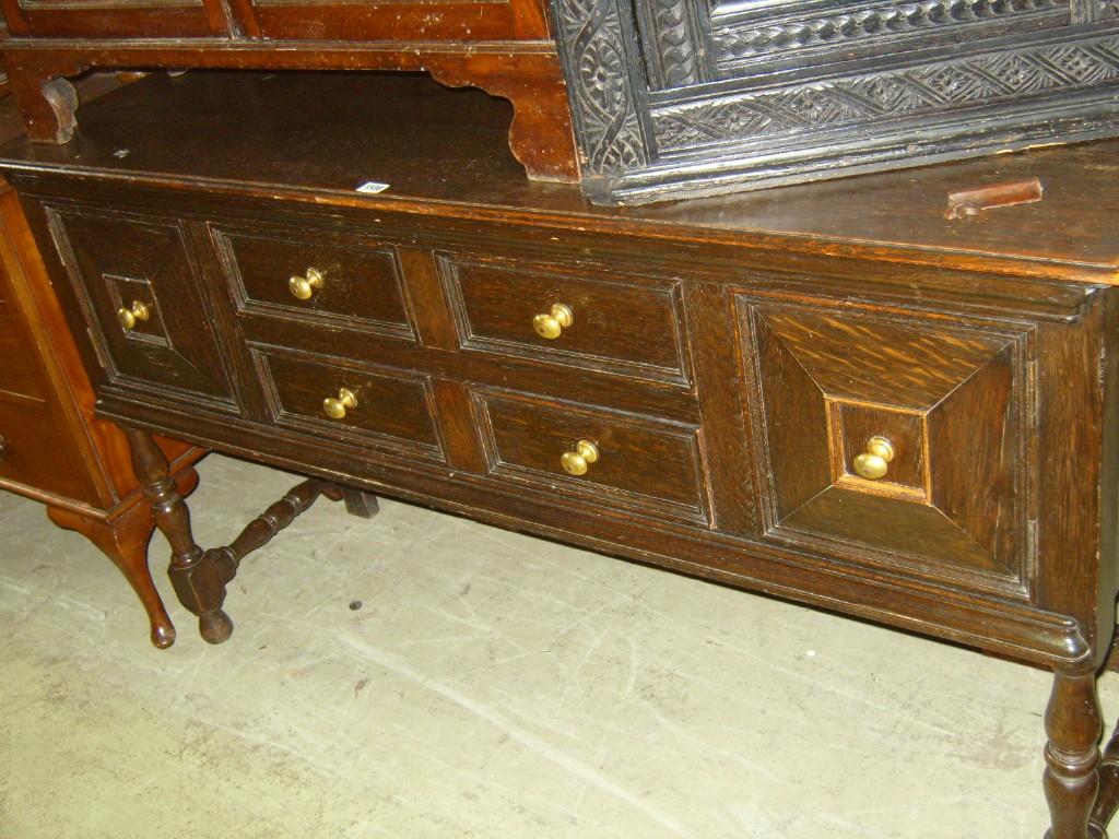 Appraisal: An Edwardian oak dresser base with low raised back the