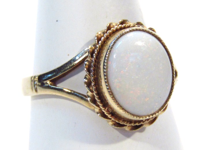 Appraisal: A ladies dress ring set with oval opal part pierced