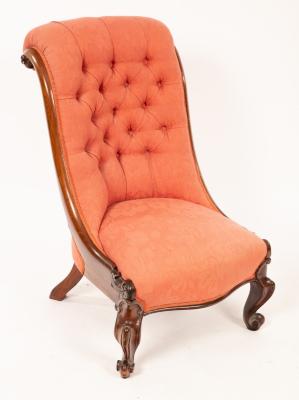 Appraisal: A Victorian upholstered scroll-shaped chair raised on carved scroll front