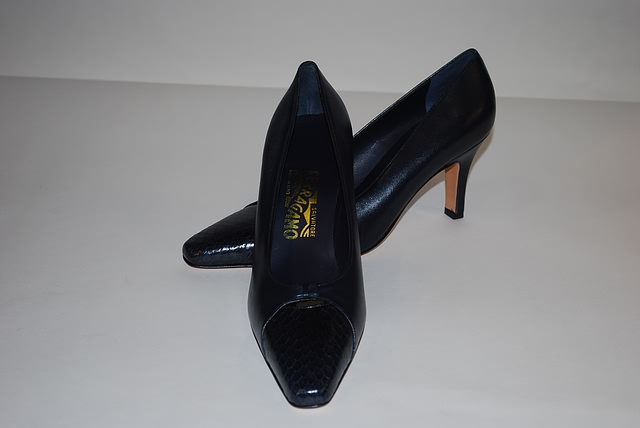 Appraisal: Salvatore Ferragamo navy leather pumps with snakeskin toe trim Size