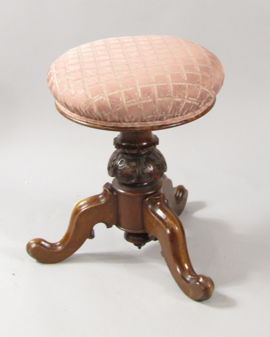 Appraisal: A Victorian mahogany piano stool with an overstuffed seat over