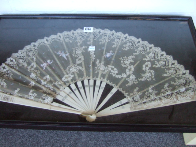 Appraisal: A painted and embroidered lace fan with bone stick guards