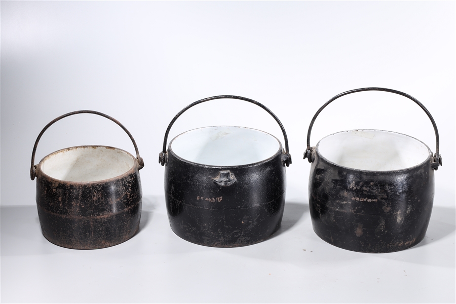 Appraisal: Group of three vintage cast iron pots from the T