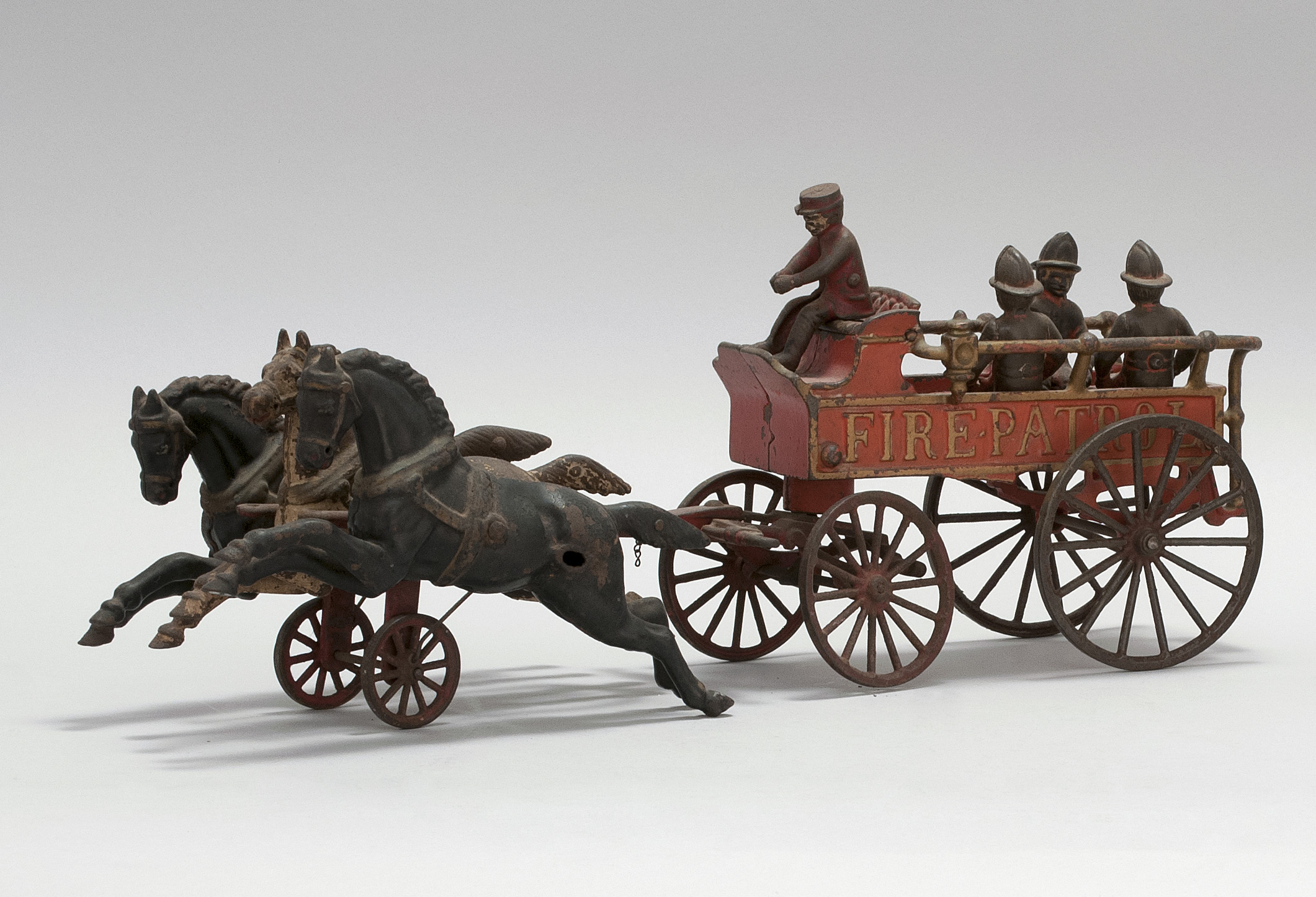 Appraisal: CAST IRON HORSE-DRAWN FIRE PATROL WAGON TOY American Circa In