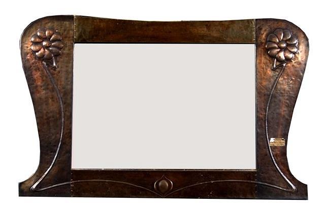 Appraisal: AN ARTS AND CRAFTS COPPER EMBOSSED OVERMANTEL MIRROR with stylised