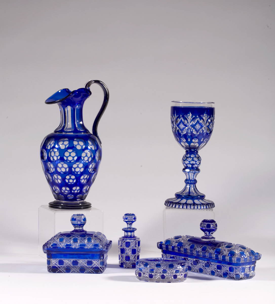 Appraisal: SIX BLUE OVERLAY CUT GLASS TABLE OBJECTS INCLUDING A EWER