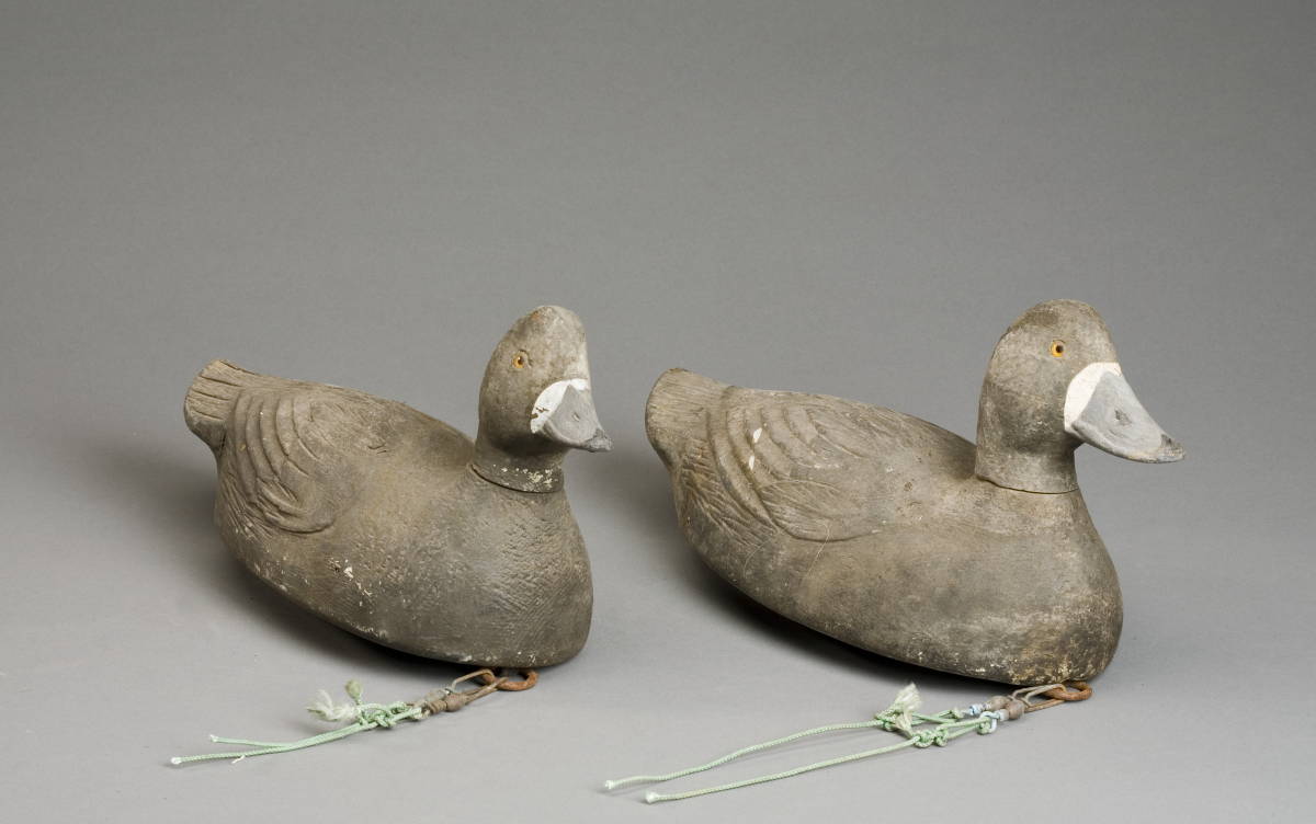 Appraisal: TWO CARVED AND PAINTED BLUEBILL HEN DECOYS ATTRIBUTED TO THE