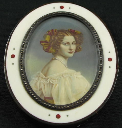 Appraisal: A MINIATURE OIL PORTRAIT of a young red-haired beauty with