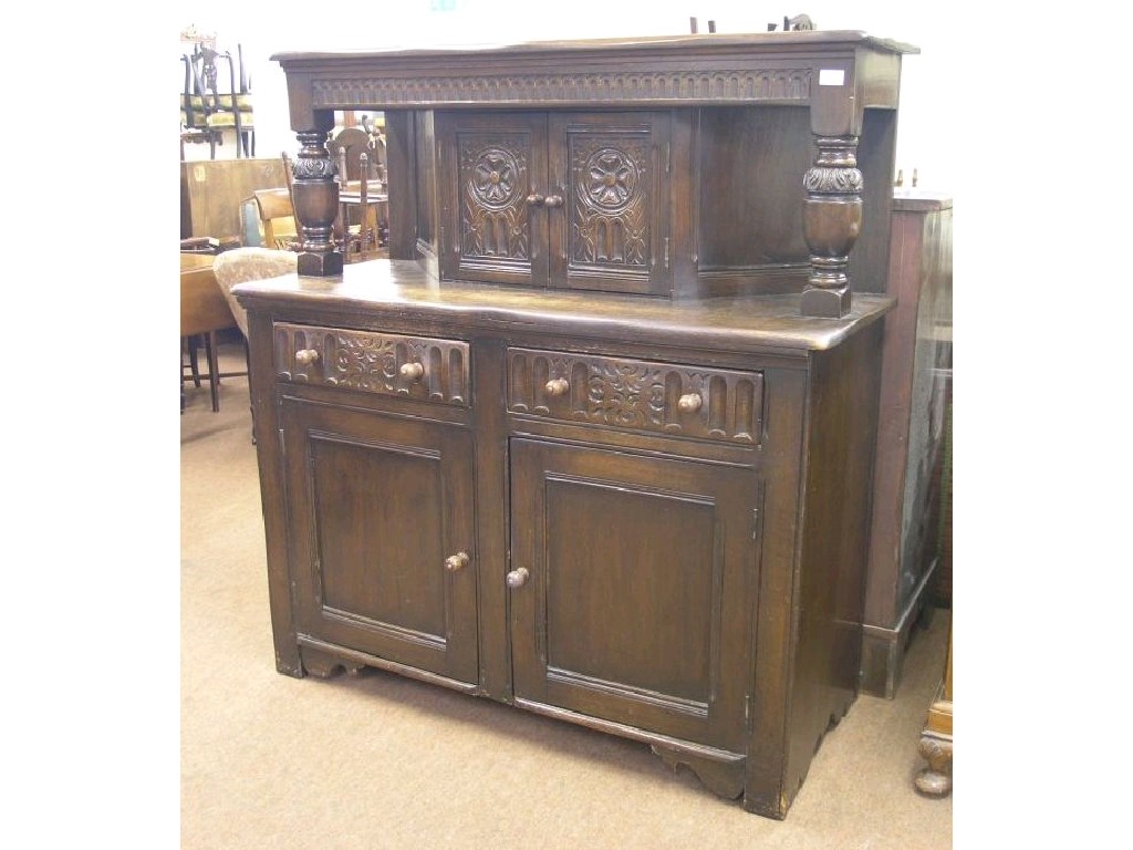 Appraisal: A dark oak court cupboard upper stage with carved and