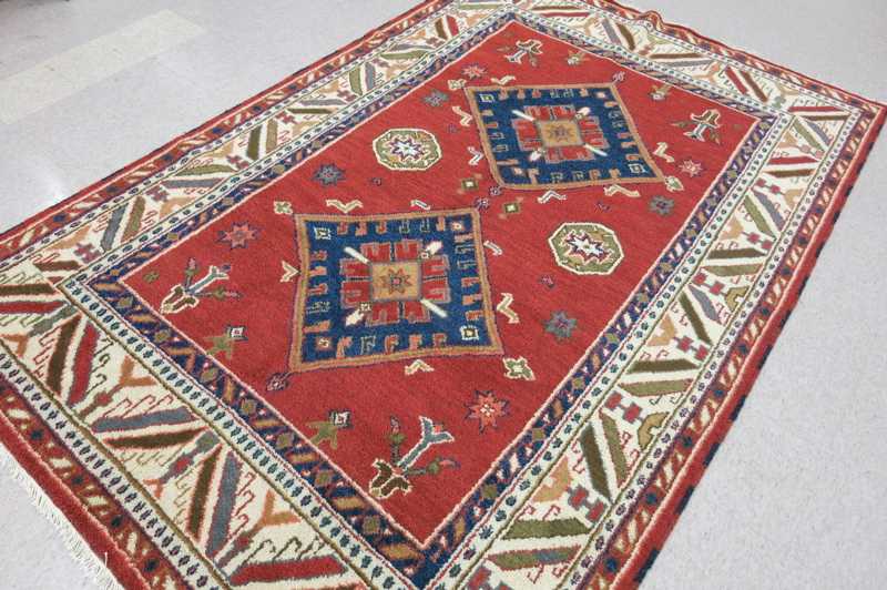 Appraisal: HAND KNOTTED ORIENTAL CARPET Indo-Caucasian double geometric medallion design on