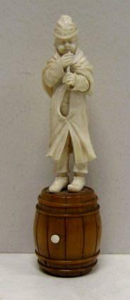 Appraisal: CARVED IVORY MUSICIAN FIGURE Standing on a wooden barrel plying