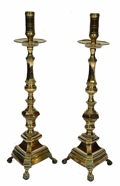 Appraisal: A PAIR OF CONTINENTAL BRASS ALTAR CANDLESTICKS of Italianate form