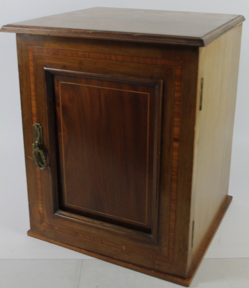 Appraisal: An Edwardian cross banded mahogany cupboard with single door cm