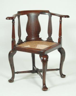 Appraisal: A COLONIAL HARDWOOD CORNER CHAIR th century the carved bow