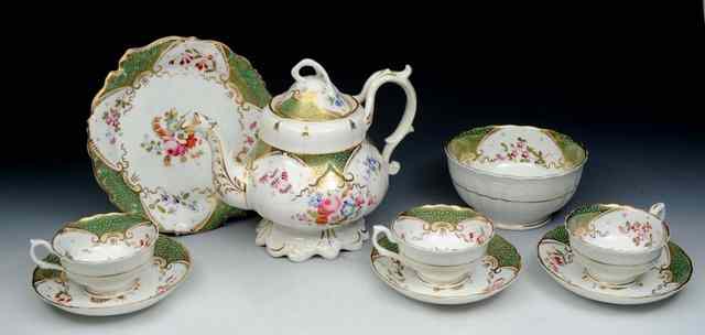 Appraisal: AN ENGLISH WHITE GROUND TEA SERVICE each piece with apple-green